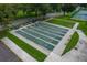 Aerial view of a well-maintained shuffleboard court surrounded by green grass, and a sidewalk at 2360 World Parkway Blvd # 36, Clearwater, FL 33763