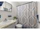 Bathroom featuring vanity with marble-style countertop, toilet, and shower with patterned curtain at 2426 Persian Dr # 52, Clearwater, FL 33763