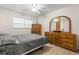 This bedroom features a ceiling fan, wood flooring, and matching wood dresser and wardrobe at 2426 Persian Dr # 52, Clearwater, FL 33763