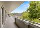 Hallway showing view of building in distance with mature trees providing privacy at 2426 Persian Dr # 52, Clearwater, FL 33763