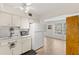Bright kitchen with appliances and view into adjacent living room offering natural light and comfortable living at 2426 Persian Dr # 52, Clearwater, FL 33763