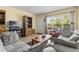 Inviting living room with large window, comfortable seating, and stylish furnishings creating a relaxing atmosphere at 2426 Persian Dr # 52, Clearwater, FL 33763