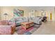Comfortable living room featuring plush seating, wood floors, and a ceiling fan at 2426 Persian Dr # 52, Clearwater, FL 33763