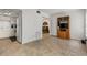 Open-concept living room with views of the kitchen and bedroom; features tile floors and media center at 2426 Persian Dr # 52, Clearwater, FL 33763