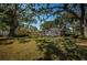 Expansive backyard featuring mature trees and a well-maintained lawn at 2880 81St N St, St Petersburg, FL 33710