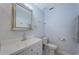 Bright bathroom featuring a vanity with a silver-trimmed mirror, toilet, and towel rack at 2880 81St N St, St Petersburg, FL 33710