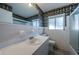 Bathroom showcasing a large mirror, window, and tile shower and floors at 2880 81St N St, St Petersburg, FL 33710