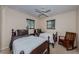 Bedroom furnished with two twin beds, ceiling fan, and rocking chair at 2880 81St N St, St Petersburg, FL 33710