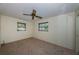 Comfortable bedroom with neutral carpet, ceiling fan, and windows at 2880 81St N St, St Petersburg, FL 33710