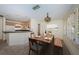 Inviting dining room with adjacent kitchen featuring neutral tones, wood furnishings and shuttered window views at 2880 81St N St, St Petersburg, FL 33710