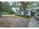 Brick driveway with surrounding mature trees and well-kept landscape adding to the charm of the property at 2880 81St N St, St Petersburg, FL 33710