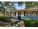 Inviting front entrance with green shutters, trimmed hedges, and an ADT security sign for added peace of mind at 2880 81St N St, St Petersburg, FL 33710