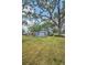 Charming single-story home featuring mature trees and manicured lawn at 2880 81St N St, St Petersburg, FL 33710