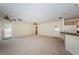 Open floor plan featuring neutral carpet and access to the kitchen and exterior at 2880 81St N St, St Petersburg, FL 33710