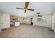 Spacious living room featuring neutral carpet, ceiling fans, and an open layout to the kitchen at 2880 81St N St, St Petersburg, FL 33710