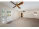 Open living space with neutral carpet, ceiling fan, and view of the backyard at 2880 81St N St, St Petersburg, FL 33710