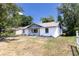 Charming single-story home with a tidy lawn and flowerbeds in front of the windows at 308 E 121St Ave, Tampa, FL 33612