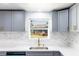Bright Kitchen sink area featuring gray cabinets, white countertop and a window to let in natural light at 308 E 121St Ave, Tampa, FL 33612