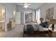 Stylishly furnished bedroom with a comfortable bed, chair, and carpeted floors at 308 S Bungalow Park Ave # B, Tampa, FL 33609