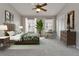 Spacious bedroom with ceiling fan, natural light, comfortable seating area, and decor at 308 S Bungalow Park Ave # B, Tampa, FL 33609