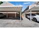 Assigned covered parking featuring white support posts and gray gravel parking spot at 308 S Bungalow Park Ave # B, Tampa, FL 33609