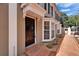 Inviting entryway featuring a classic black door, brick path, and bay windows, enhancing curb appeal at 308 S Bungalow Park Ave # B, Tampa, FL 33609
