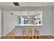Modern kitchen with bar seating, white cabinets, stainless appliances, and a view of the patio at 308 S Bungalow Park Ave # B, Tampa, FL 33609