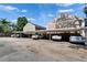 Covered parking spaces available for residents with lush trees and plants nearby at 308 S Bungalow Park Ave # B, Tampa, FL 33609