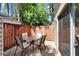 Private patio with brick floor, outdoor table and chairs, and wood fence at 308 S Bungalow Park Ave # B, Tampa, FL 33609