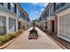 Beautiful townhomes with brick-paved walkway, landscaping, and black bench at 308 S Bungalow Park Ave # B, Tampa, FL 33609