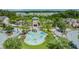 Aerial image features a community splash pad with interactive water features, set against a backdrop of palm trees and homes at 32713 Brooks Hawk Ln, Wesley Chapel, FL 33543