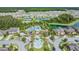 Aerial perspective of a community pool, splash pad, and playground, perfect for Gathering fun and relaxation at 32713 Brooks Hawk Ln, Wesley Chapel, FL 33543