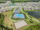 High-angle view of a community pool with a basketball court, all set within a beautifully landscaped area at 32713 Brooks Hawk Ln, Wesley Chapel, FL 33543