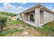 Private backyard with a covered patio, lush lawn, and mature landscaping at 32713 Brooks Hawk Ln, Wesley Chapel, FL 33543