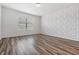 Bedroom featuring new floors, fresh paint, blinds, and an accent wall at 32713 Brooks Hawk Ln, Wesley Chapel, FL 33543