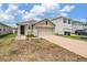 Well-maintained single-Gathering home with a front yard, driveway, and attached garage at 32713 Brooks Hawk Ln, Wesley Chapel, FL 33543