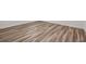 Angle on new floors showing neutral hues and new baseboards with clean paint at 32713 Brooks Hawk Ln, Wesley Chapel, FL 33543