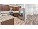 Modern kitchen boasts stainless steel appliances, granite countertops, and stylish cabinets at 32713 Brooks Hawk Ln, Wesley Chapel, FL 33543