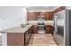 Modern kitchen featuring stainless steel appliances, granite countertops, and dark wood cabinets at 32713 Brooks Hawk Ln, Wesley Chapel, FL 33543