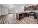Modern kitchen featuring stainless steel appliances, granite countertops, and dark wood cabinets at 32713 Brooks Hawk Ln, Wesley Chapel, FL 33543