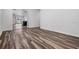 Inviting living room with modern wood flooring seamlessly flowing into adjacent spaces at 32713 Brooks Hawk Ln, Wesley Chapel, FL 33543