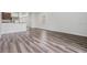 Living room featuring wood-look flooring, neutral paint, and view to the kitchen at 32713 Brooks Hawk Ln, Wesley Chapel, FL 33543