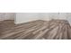 Spacious living room featuring modern wood flooring and fresh neutral paint at 32713 Brooks Hawk Ln, Wesley Chapel, FL 33543