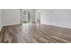 Living room featuring new floors, neutral paint, and sliding glass doors to the backyard at 32713 Brooks Hawk Ln, Wesley Chapel, FL 33543