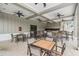 Covered patio area with wooden tables, chairs and bar stool seating at 32713 Brooks Hawk Ln, Wesley Chapel, FL 33543