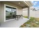 Covered patio featuring sleek outdoor seating, perfect for entertaining or relaxing at 32713 Brooks Hawk Ln, Wesley Chapel, FL 33543
