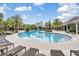 Resort-style community pool with tanning deck, lounge chairs and beautifully landscaped surroundings at 32713 Brooks Hawk Ln, Wesley Chapel, FL 33543