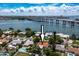Aerial view of home with pool in quiet neighborhood with lush landscaping at 3555 Belle Vista E Dr, St Pete Beach, FL 33706