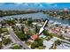 Home with a pool in a waterfront community with scenic bay view, captured from above at 3555 Belle Vista E Dr, St Pete Beach, FL 33706