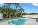 Enjoy the Florida sunshine in this backyard oasis with a kidney-shaped pool and lush landscaping at 3555 Belle Vista E Dr, St Pete Beach, FL 33706